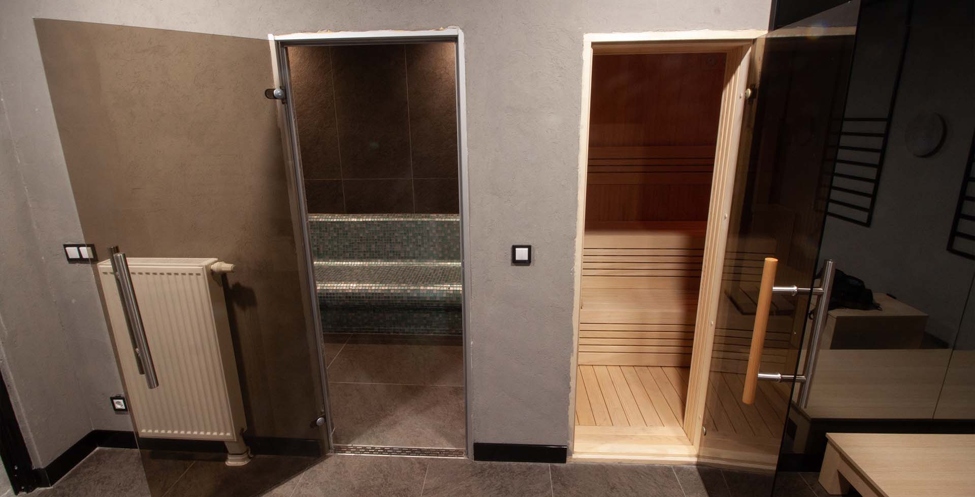 entrance to a steam room and sauna, featuring a welcoming door with frosted glass panels, soft lighting, and a serene ambiance.